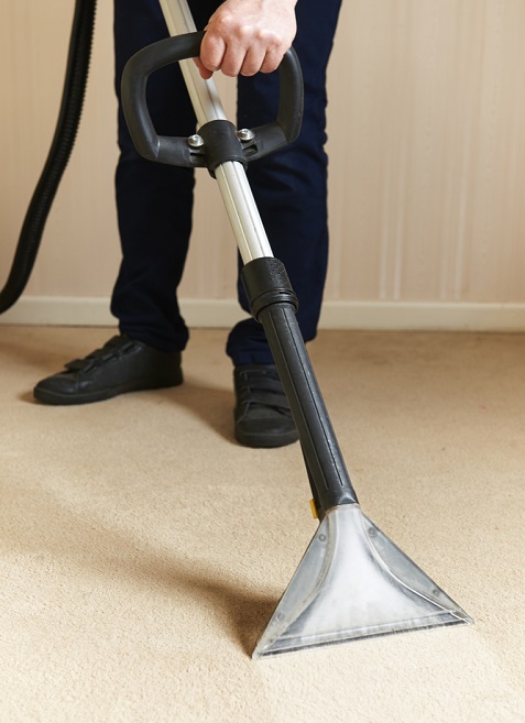 Man cleaning via Vacuum Cleaner